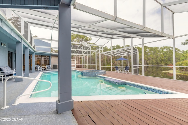 view of swimming pool with a wooden deck, a patio, a lanai, and a pool with connected hot tub