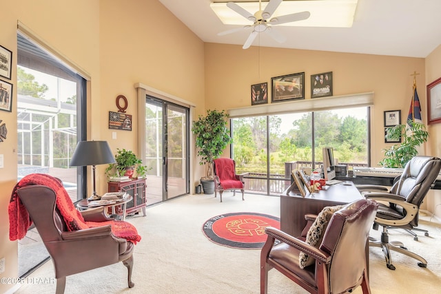 carpeted office space featuring plenty of natural light, a ceiling fan, and high vaulted ceiling