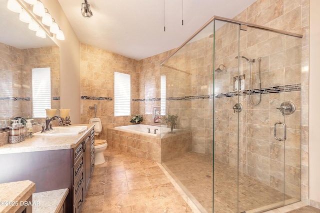 full bathroom with tile walls, a stall shower, vanity, and a bath