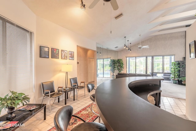 office with vaulted ceiling, light tile patterned flooring, and a healthy amount of sunlight