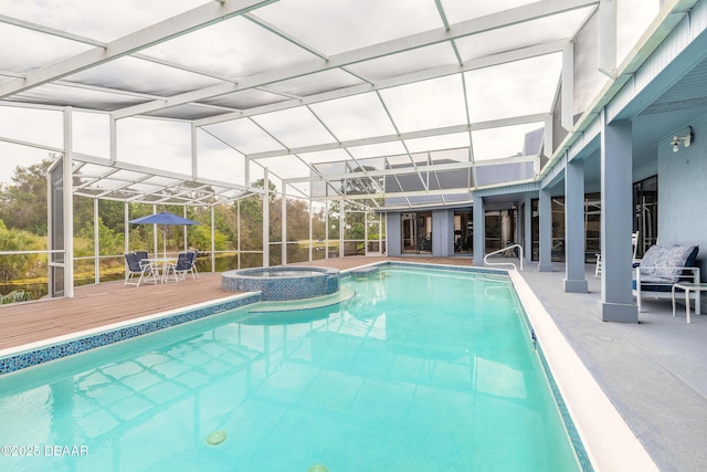 view of swimming pool with glass enclosure, a patio, a deck, and a pool with connected hot tub