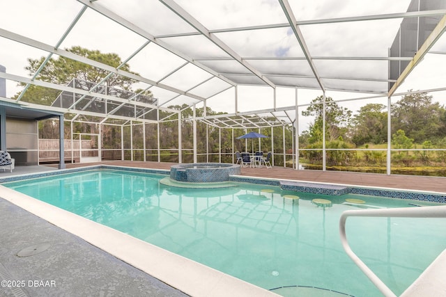 view of swimming pool with glass enclosure, a patio, and a pool with connected hot tub