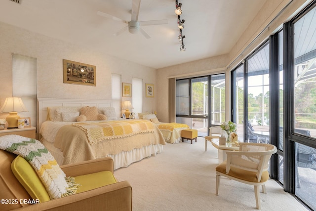 bedroom featuring access to exterior, carpet flooring, track lighting, and visible vents