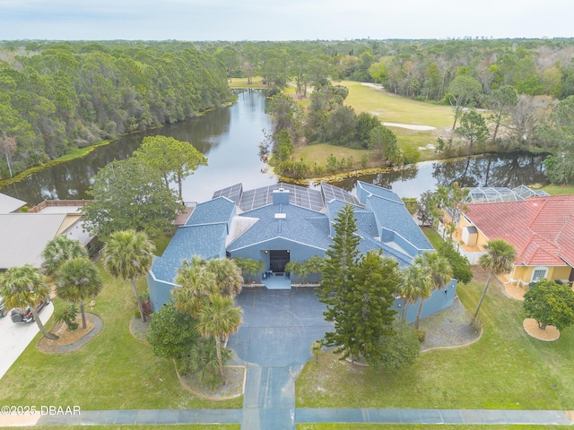 birds eye view of property featuring a forest view and a water view