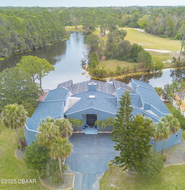 birds eye view of property featuring a wooded view and a water view