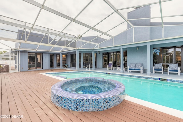 view of pool featuring glass enclosure, an outdoor living space, a pool with connected hot tub, a deck, and a patio area