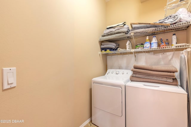 washroom with laundry area, independent washer and dryer, and baseboards