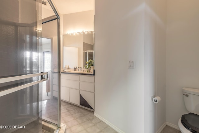 bathroom with vanity, toilet, and baseboards