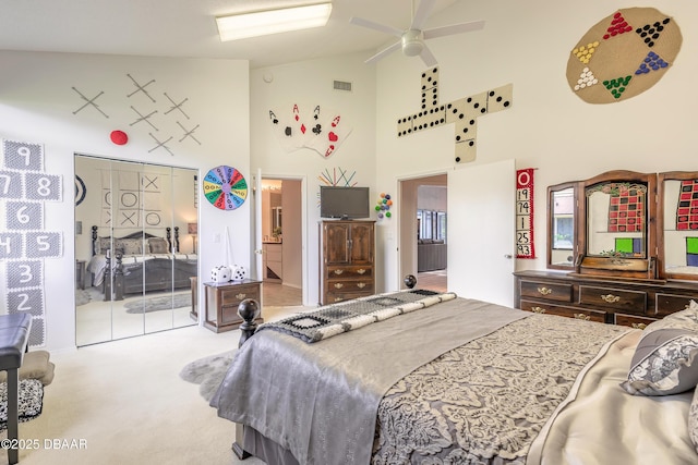 carpeted bedroom with visible vents and high vaulted ceiling