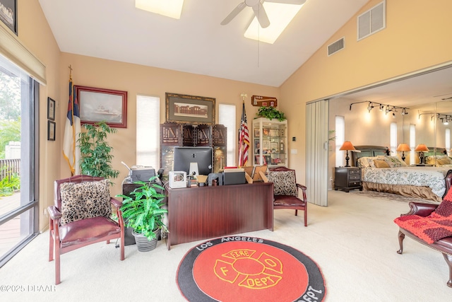 interior space featuring a ceiling fan, carpet, visible vents, and high vaulted ceiling