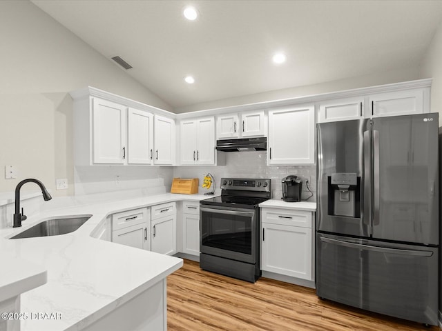 kitchen with white cabinetry, appliances with stainless steel finishes, sink, and light hardwood / wood-style flooring