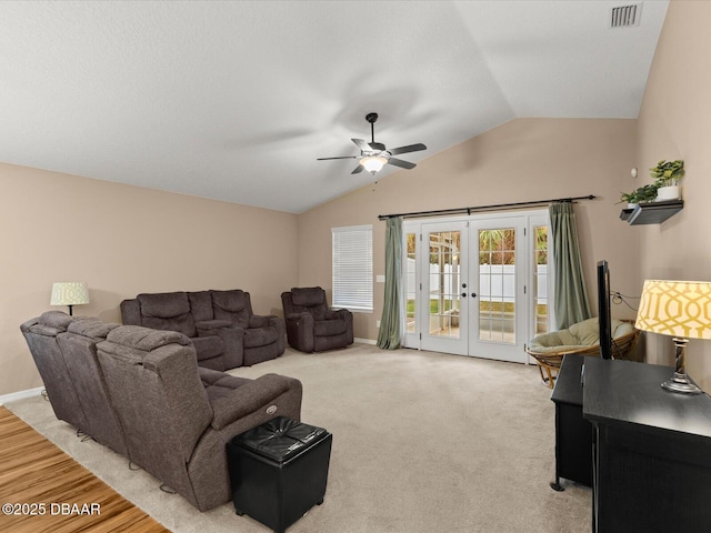 living room with light carpet, vaulted ceiling, french doors, and ceiling fan