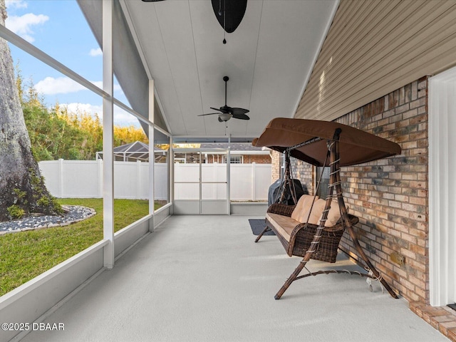 unfurnished sunroom featuring a healthy amount of sunlight and ceiling fan