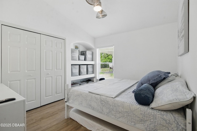 3348 Heath Dr, Deltona, FL 32725 - bedroom featuring lofted ceiling, wood finished floors, and a closet