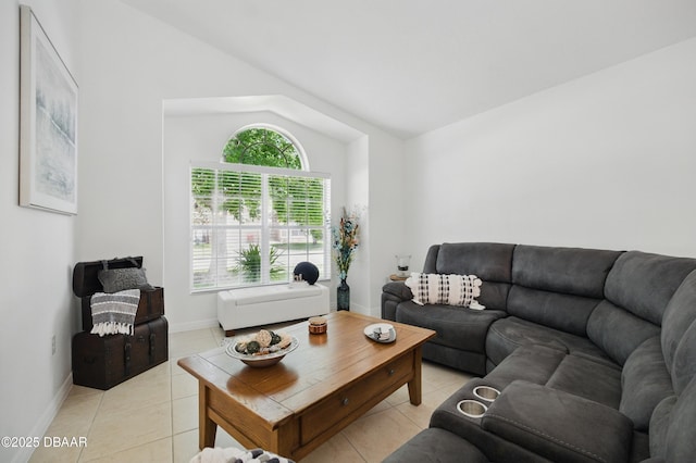 3348 Heath Dr, Deltona, FL 32725 - living area featuring light tile patterned floors, lofted ceiling, and baseboards
