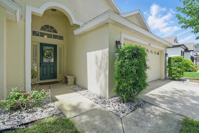 3348 Heath Dr, Deltona, FL 32725 - entrance to property with stucco siding, a garage, and concrete driveway