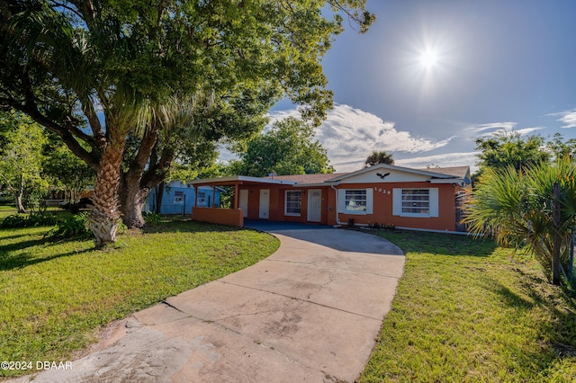 ranch-style home featuring a front yard