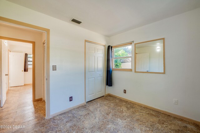 unfurnished bedroom with a closet