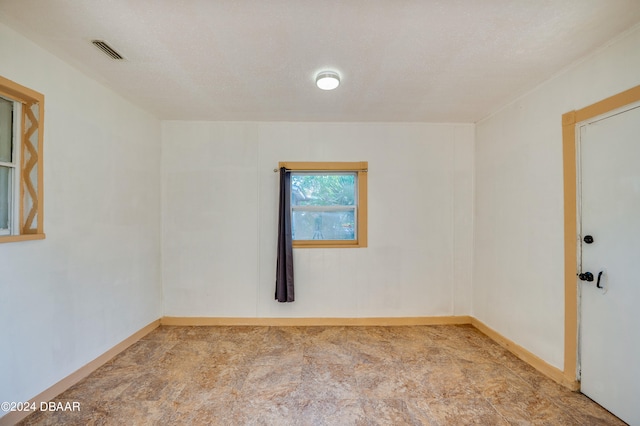 empty room featuring a textured ceiling