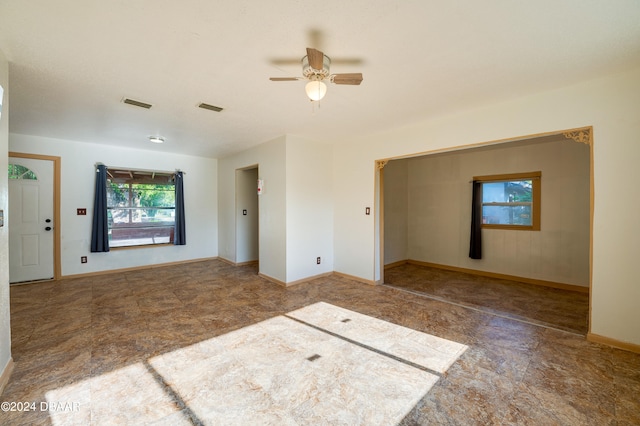 unfurnished living room with plenty of natural light and ceiling fan