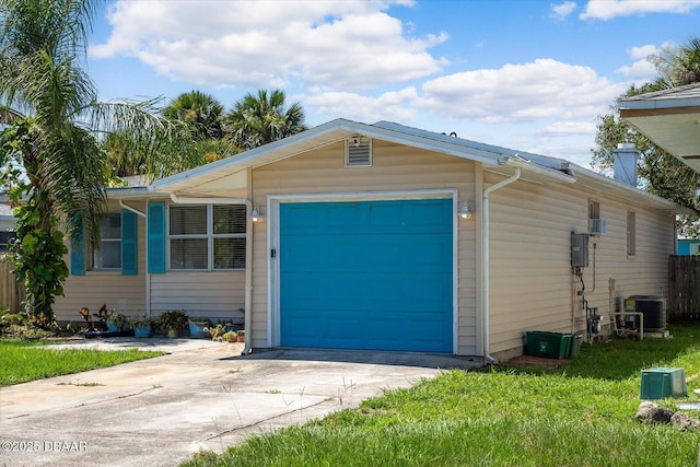 garage featuring central AC and a lawn