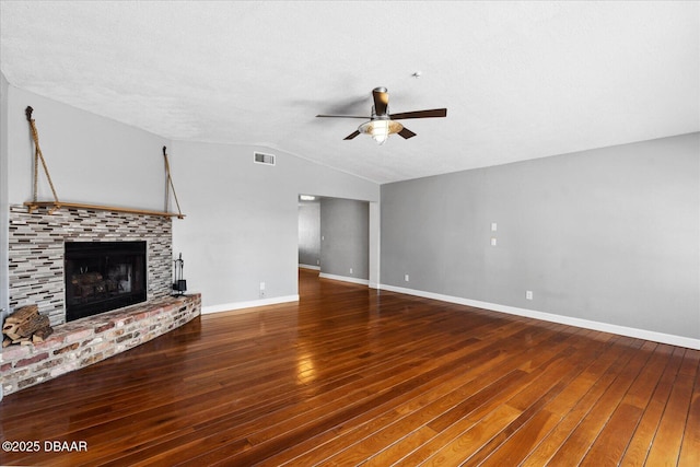 unfurnished living room featuring ceiling fan, dark hardwood / wood-style flooring, and vaulted ceiling