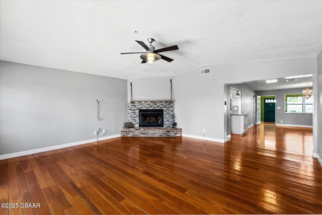 unfurnished living room with hardwood / wood-style floors, a textured ceiling, vaulted ceiling, and ceiling fan