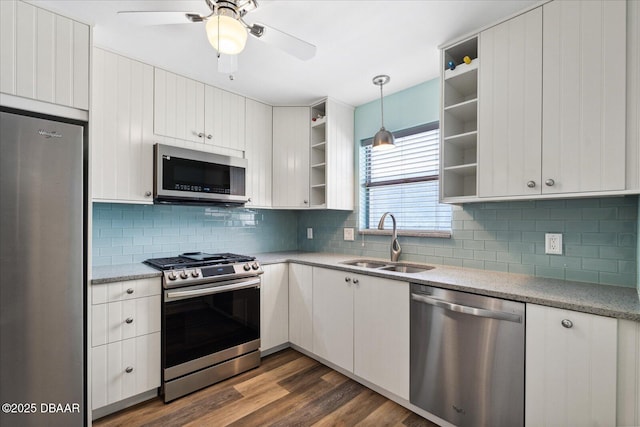 kitchen with pendant lighting, sink, white cabinetry, and stainless steel appliances