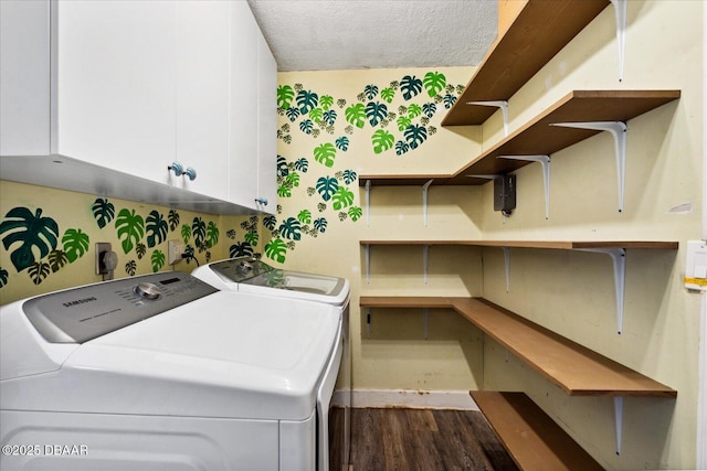 washroom with washing machine and dryer, dark hardwood / wood-style flooring, cabinets, and a textured ceiling