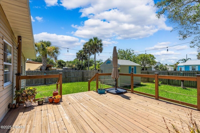 deck featuring a yard and a storage shed