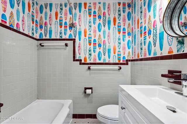 bathroom featuring a washtub, toilet, tile walls, and vanity