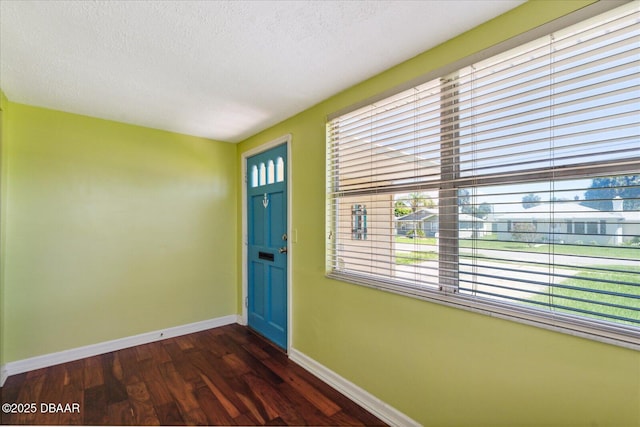 entryway featuring a textured ceiling and dark hardwood / wood-style floors