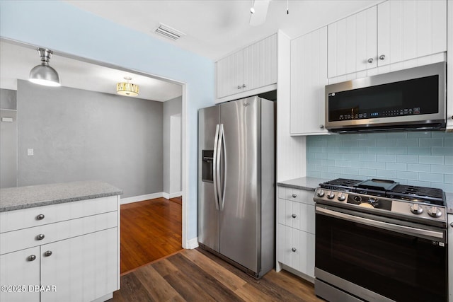 kitchen with white cabinets, dark hardwood / wood-style floors, and appliances with stainless steel finishes