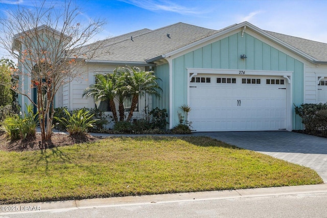 single story home featuring a garage and a front yard