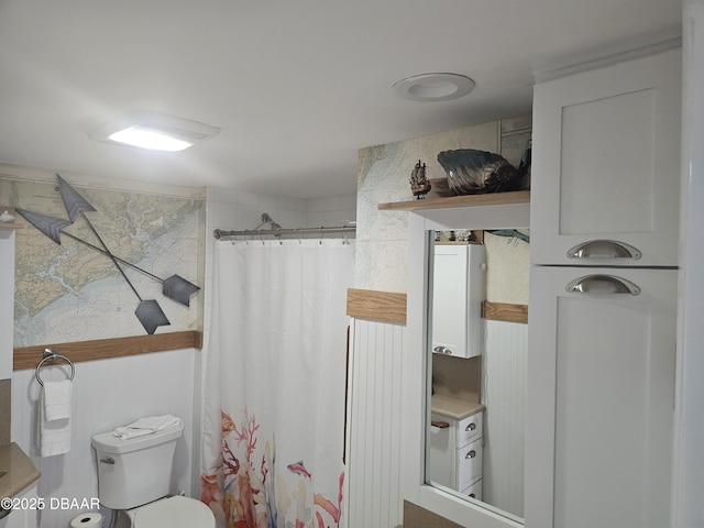 bathroom featuring toilet and a shower with shower curtain