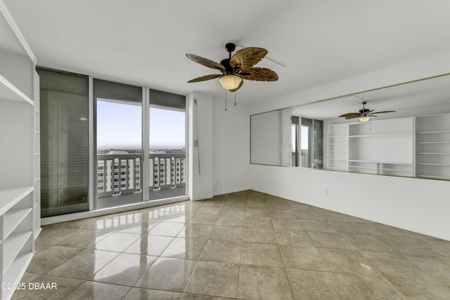 2800 N Atlantic Ave Unit 1712, Daytona Beach, FL 32118 - tiled empty room featuring a ceiling fan, healthy amount of natural light, and a wall of windows