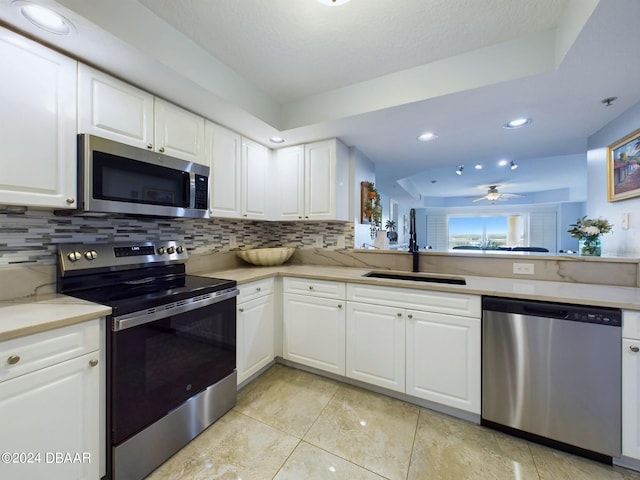 4670 Links Village Dr Unit C601, Ponce Inlet, FL 32127 - kitchen with appliances with stainless steel finishes, backsplash, a ceiling fan, light countertops, and recessed lighting