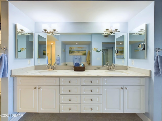 4670 Links Village Dr Unit C601, Ponce Inlet, FL 32127 - full bath featuring double vanity, a shower with shower door, a chandelier, and tile patterned floors