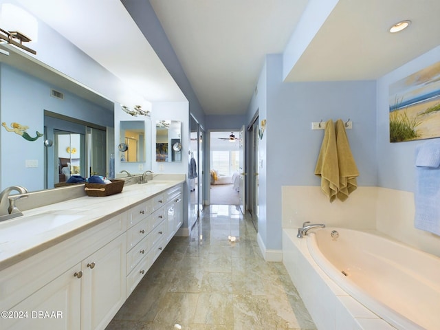 4670 Links Village Dr Unit C601, Ponce Inlet, FL 32127 - bathroom with double vanity, a garden tub, marble finish flooring, and a ceiling fan