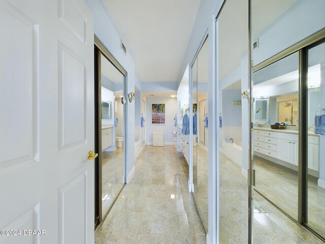 4670 Links Village Dr Unit C601, Ponce Inlet, FL 32127 - corridor featuring light marble finish floors