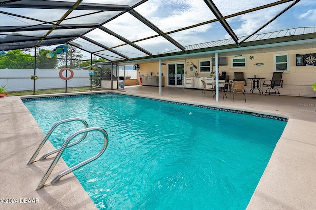 view of swimming pool with a lanai and a patio