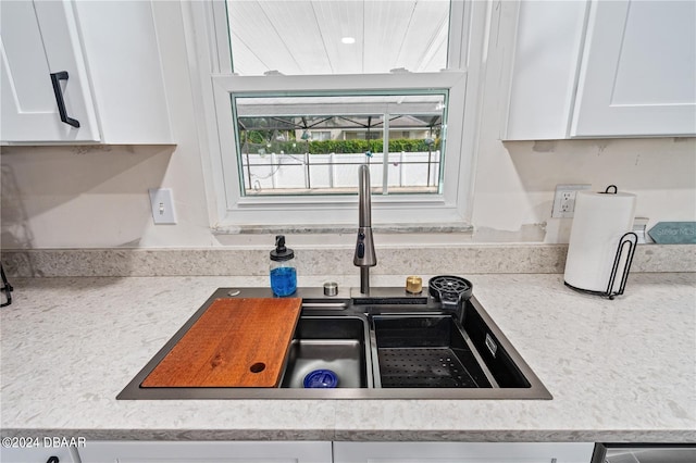 kitchen with white cabinetry and sink