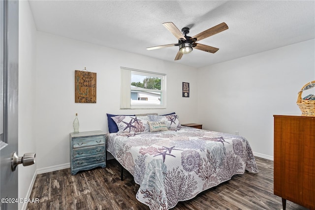 bedroom featuring ceiling fan, dark hardwood / wood-style flooring, and a textured ceiling