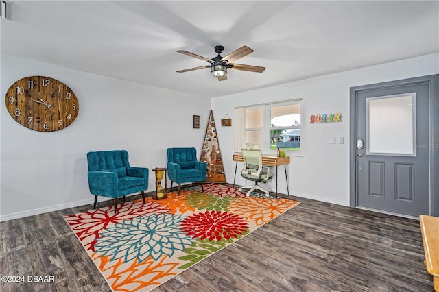 living area featuring ceiling fan and dark hardwood / wood-style flooring