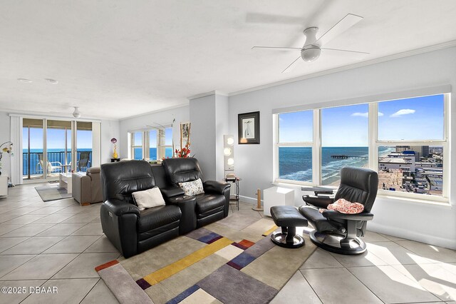 sitting room featuring ceiling fan, ornamental molding, and light tile patterned floors