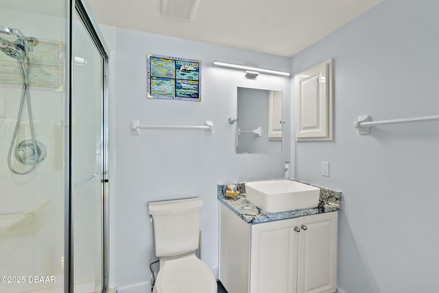 bathroom with vanity, an enclosed shower, and toilet