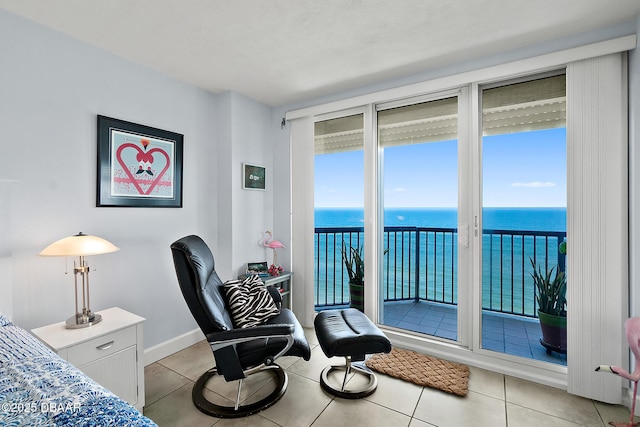 bedroom featuring access to outside, light tile patterned flooring, and a water view