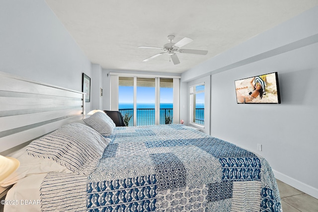 tiled bedroom featuring a water view, ceiling fan, and access to exterior