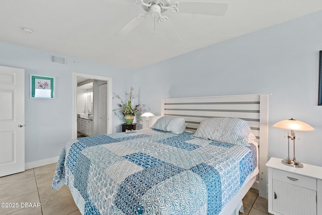 tiled bedroom with ceiling fan and ensuite bath