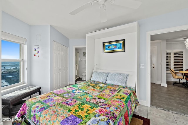 tiled bedroom with ensuite bath, a closet, and ceiling fan